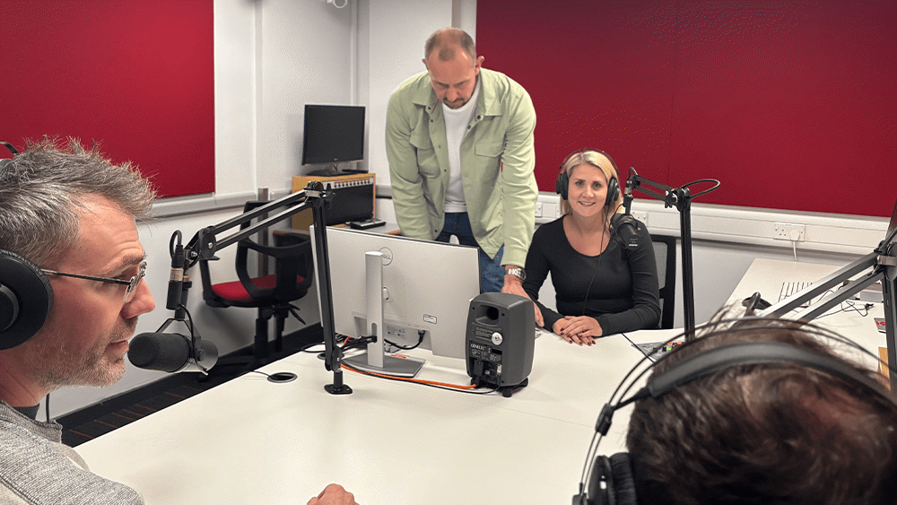 Four people in a podcast studio on campus at Southampton Solent University.