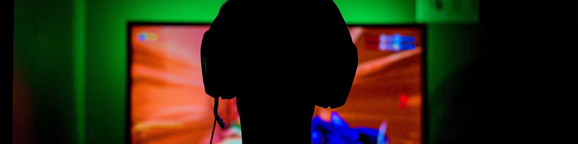 Someone with headphones looking at a screen