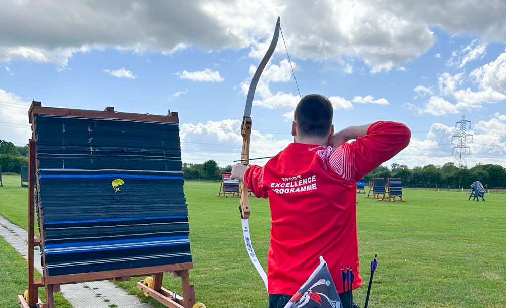 Rob draws his bow in practice