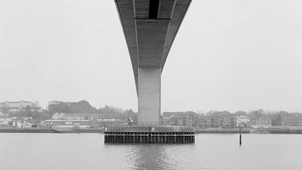 A black and white photograph of the River Itchen and Ocean Village, from across the water.