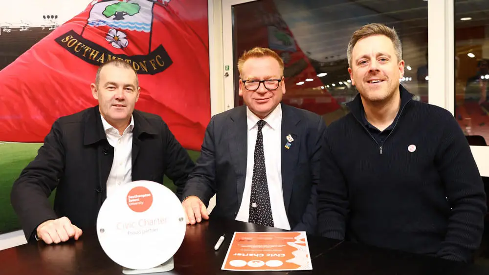 Professor James Knowles signs the charter with Phil Parsons and Sam Fulling