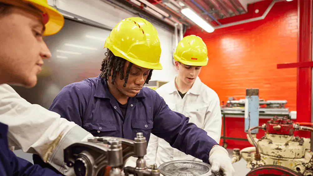 Three students working in the engineering workshop of the new SMART centre
