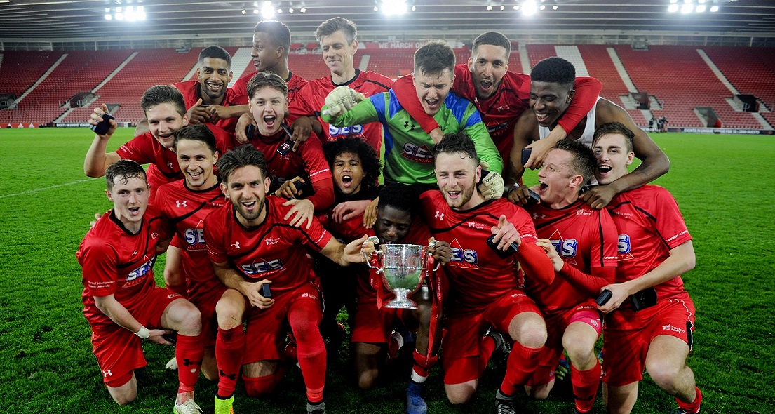 Team Solent football club with their trophy