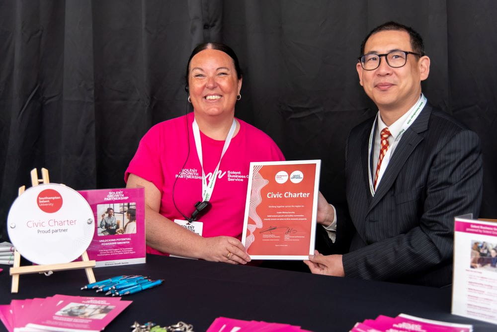 (L-R) Jodi Fair holding the signed Civic Charter with Professor Andy Chan 