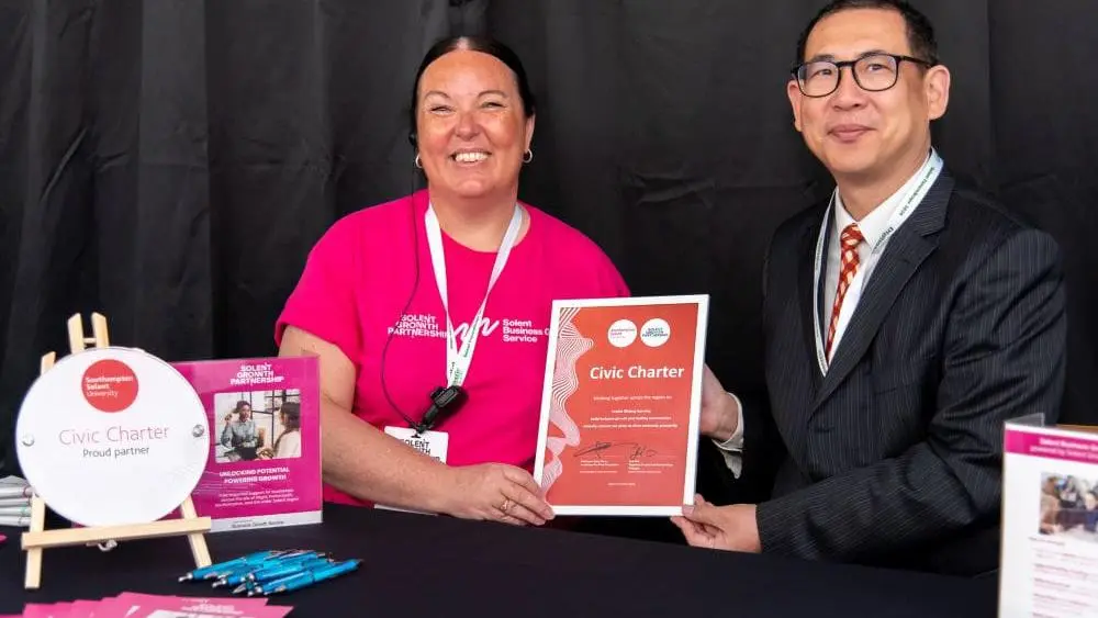 (L-R) Jodi Fair holding the signed Civic Charter with Professor Andy Chan