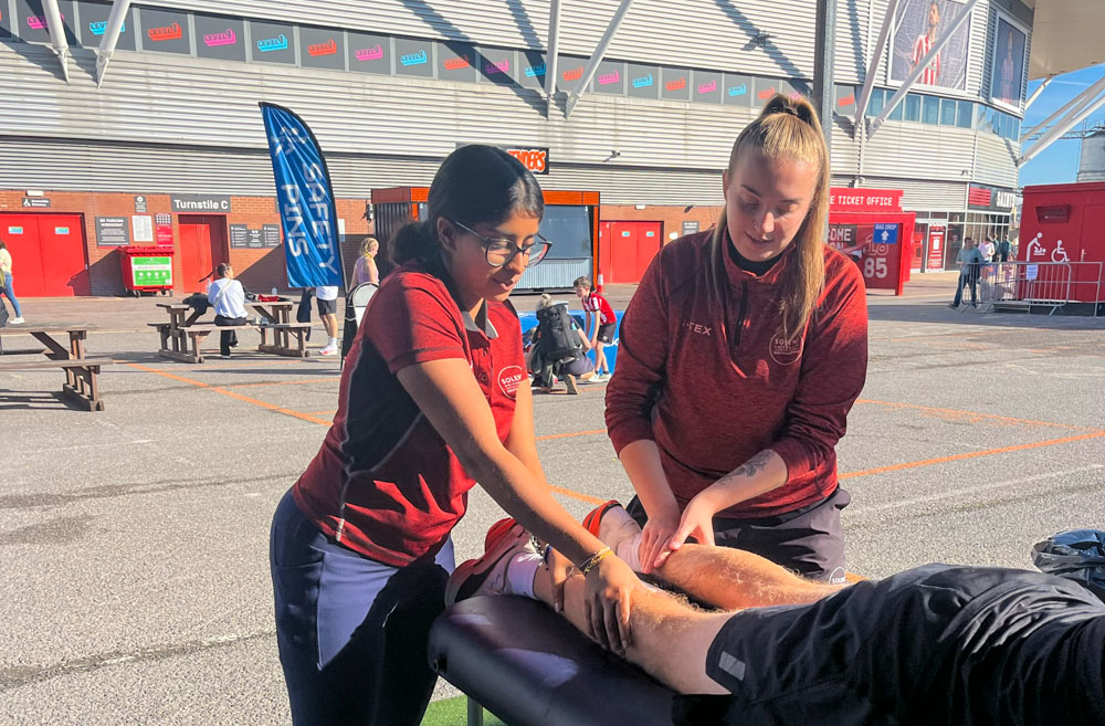 Sports therapy students supporting a runner