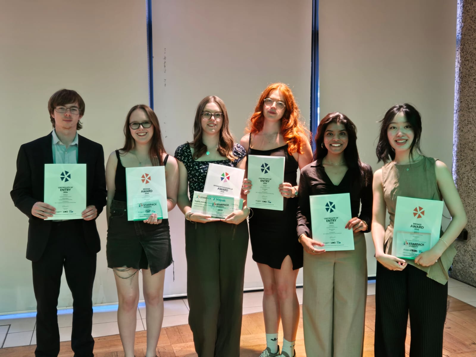 students standing with starpack student awards