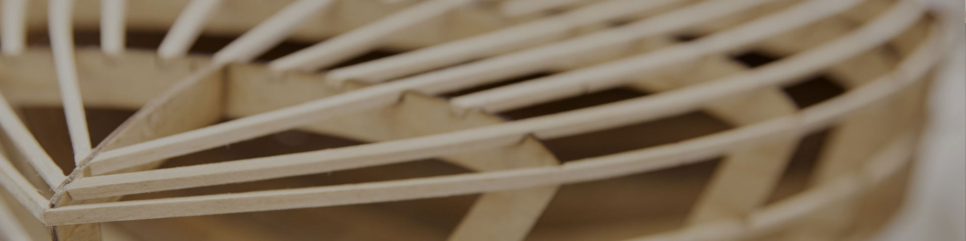 Close-up of the wooden structure of a model yacht's hull