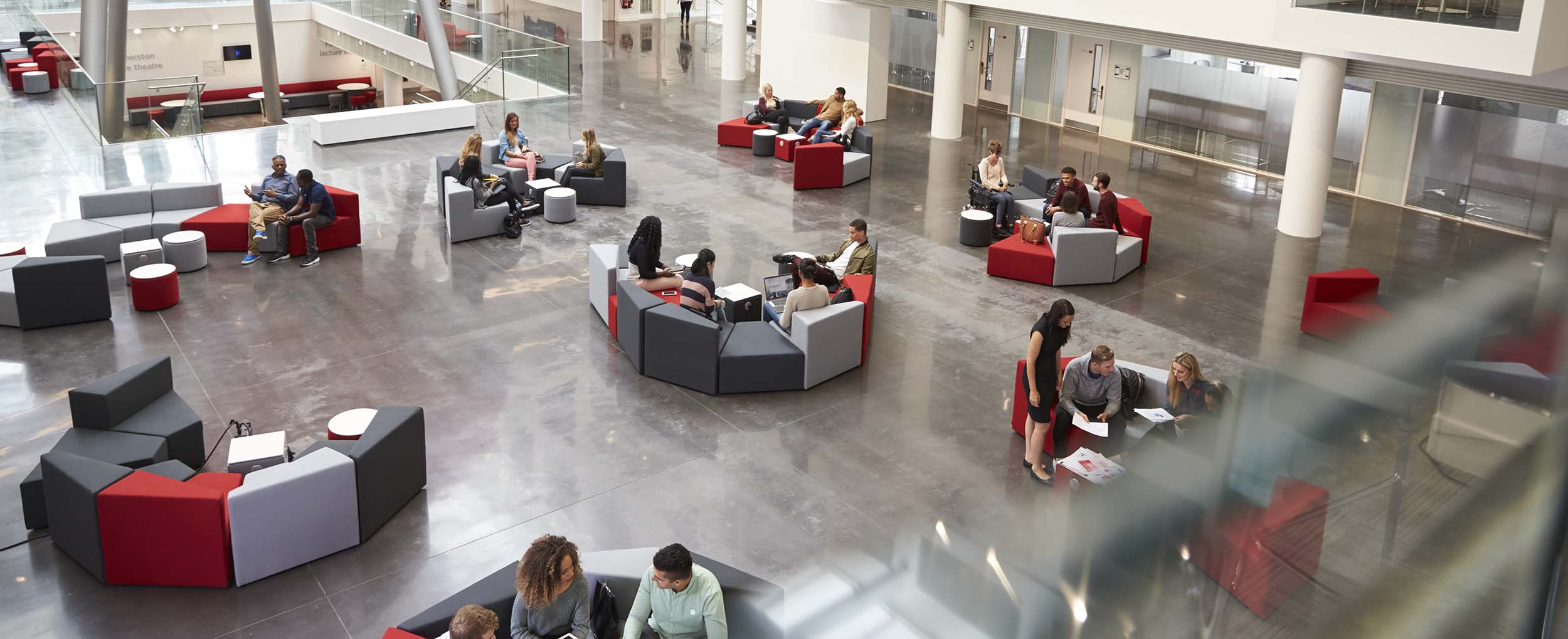 Students sat on sofas in The Spark atrium