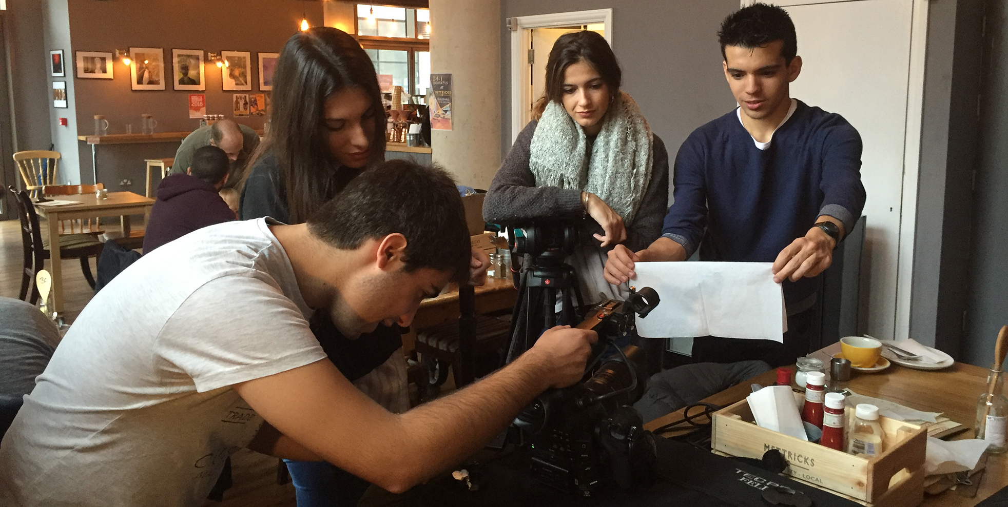 Students filming in a coffee shop
