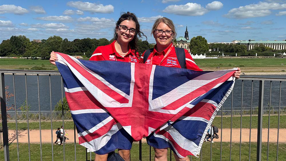 Students holding Union Jack at the Games