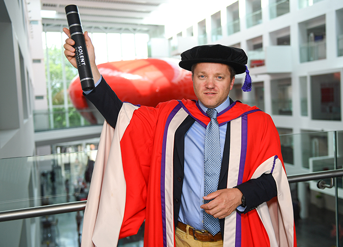 James Roy with his degree in The Spark