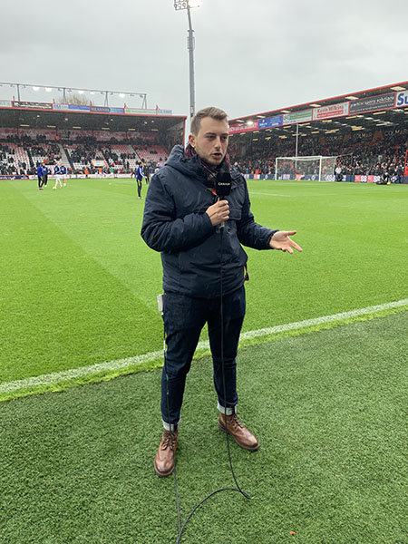 BA (Hons) Sports Journalism student, Sébastien Zany reporting from the pitch at the Vitality Stadium