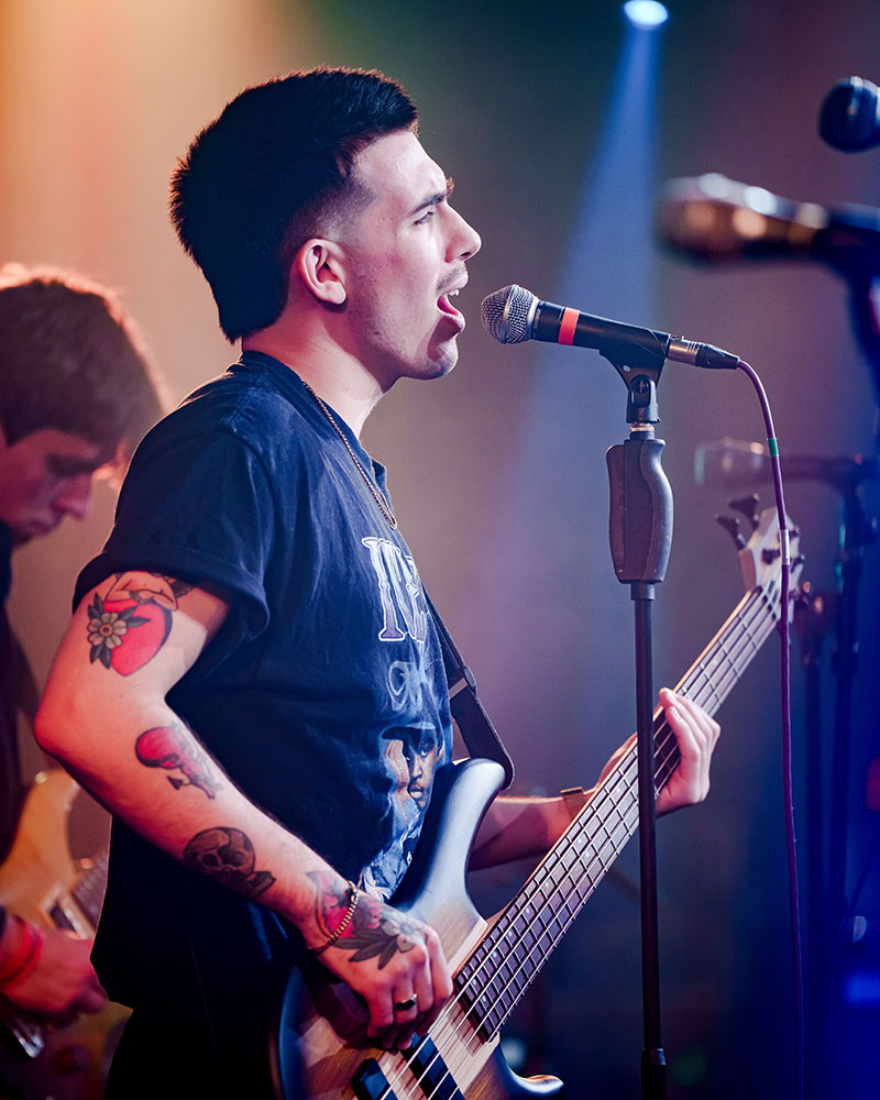 Male performer playing guitar and singing