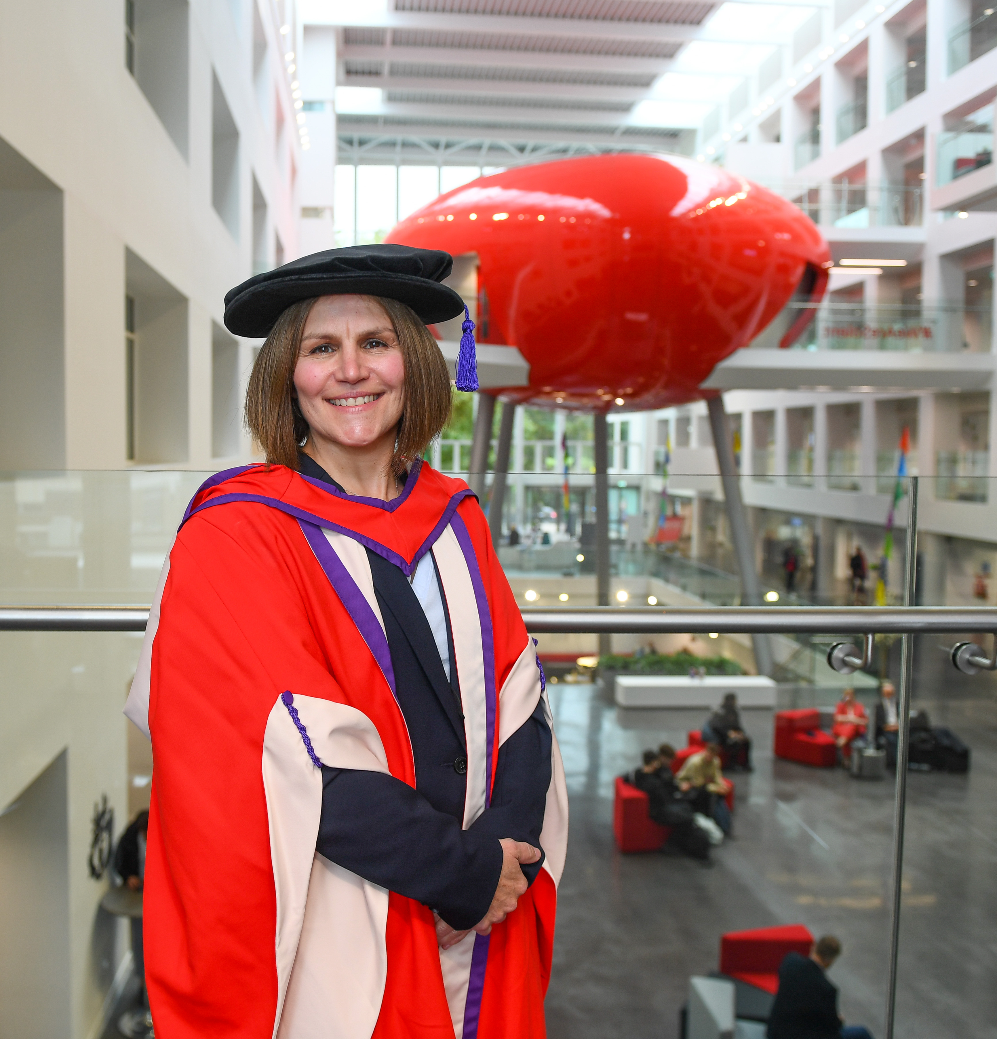 Mags Arnold in her ceremonial gowns in The Spark atrium