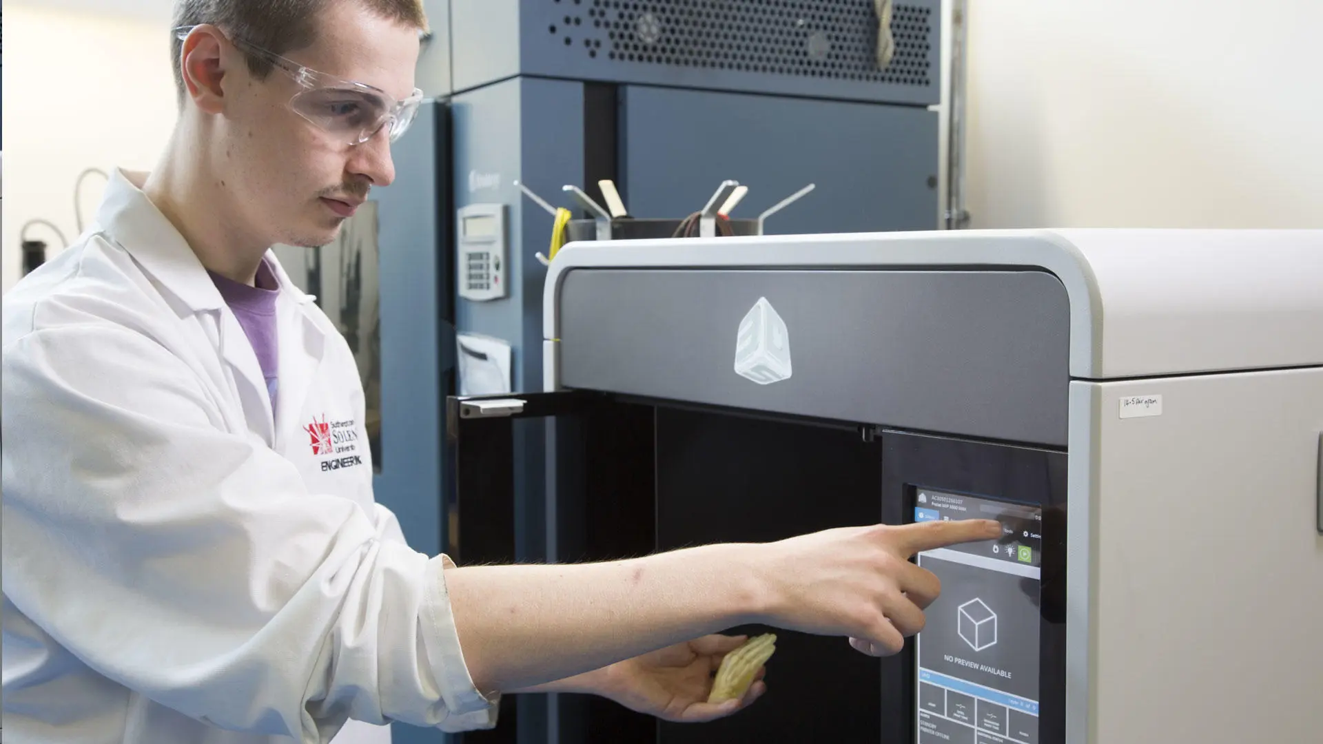 A student using equipment in the advanced manufacturing lab