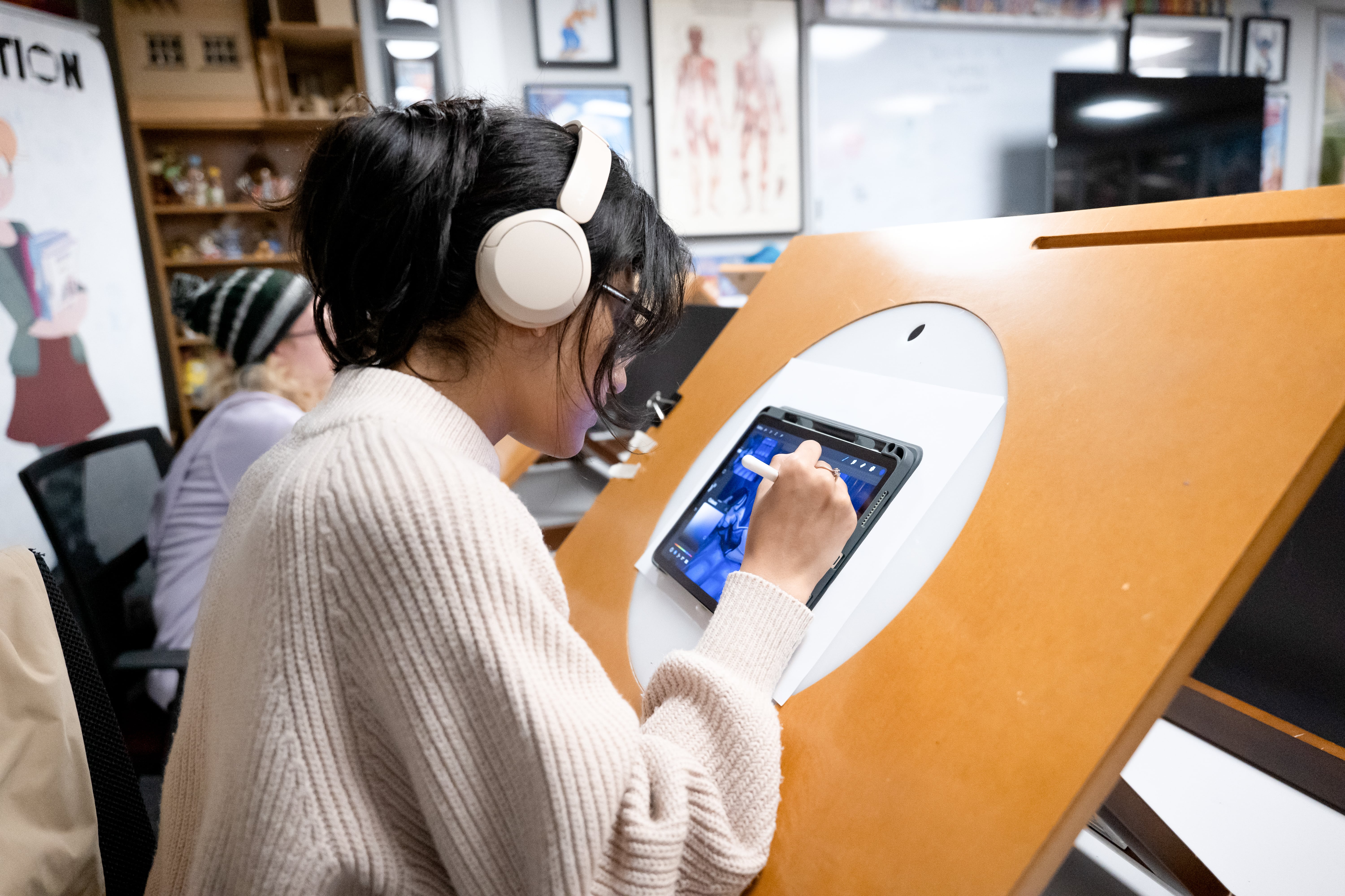 Student working on a digital tablet on a lightbox