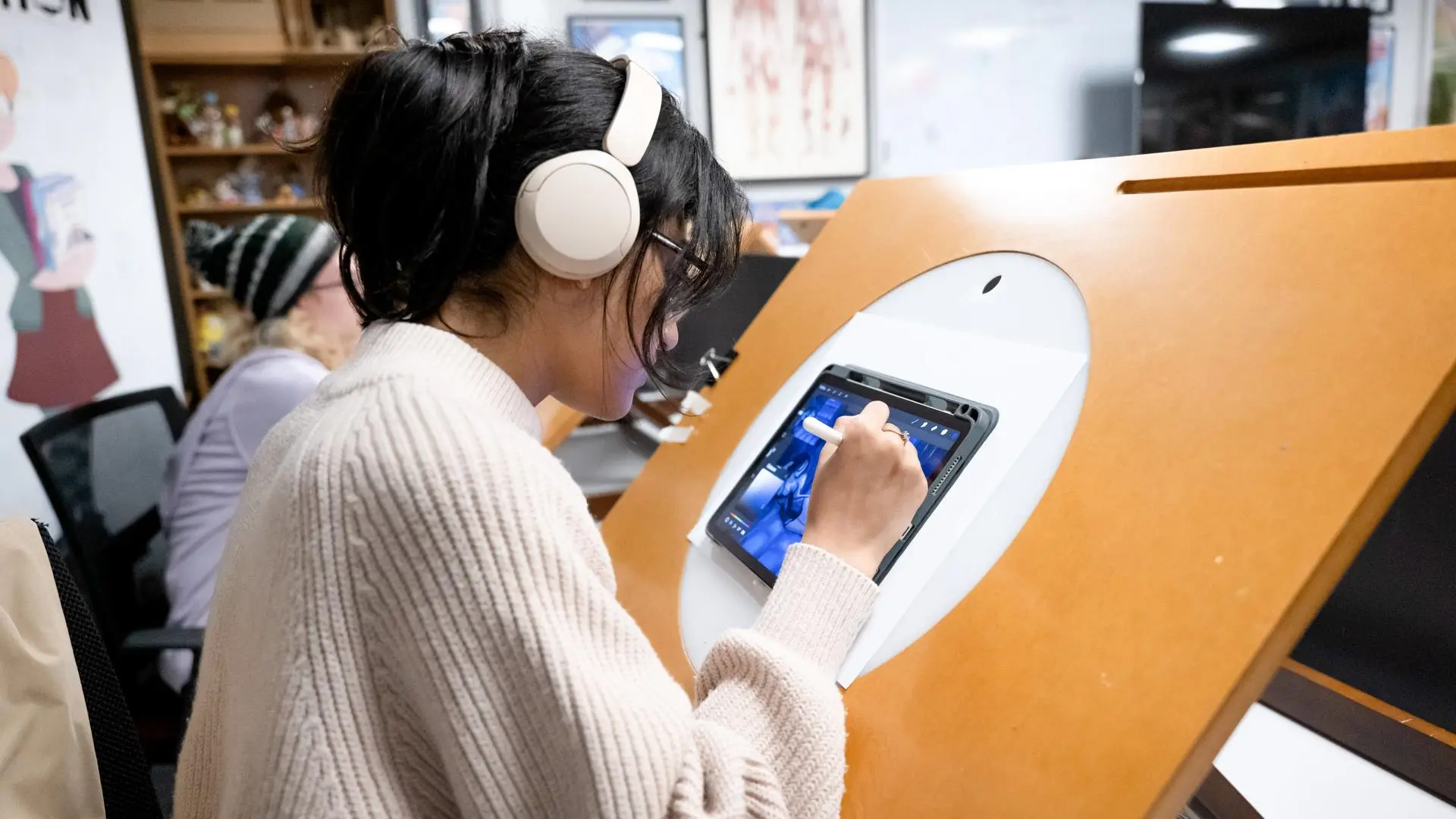 Student working on a digital tablet on a lightbox