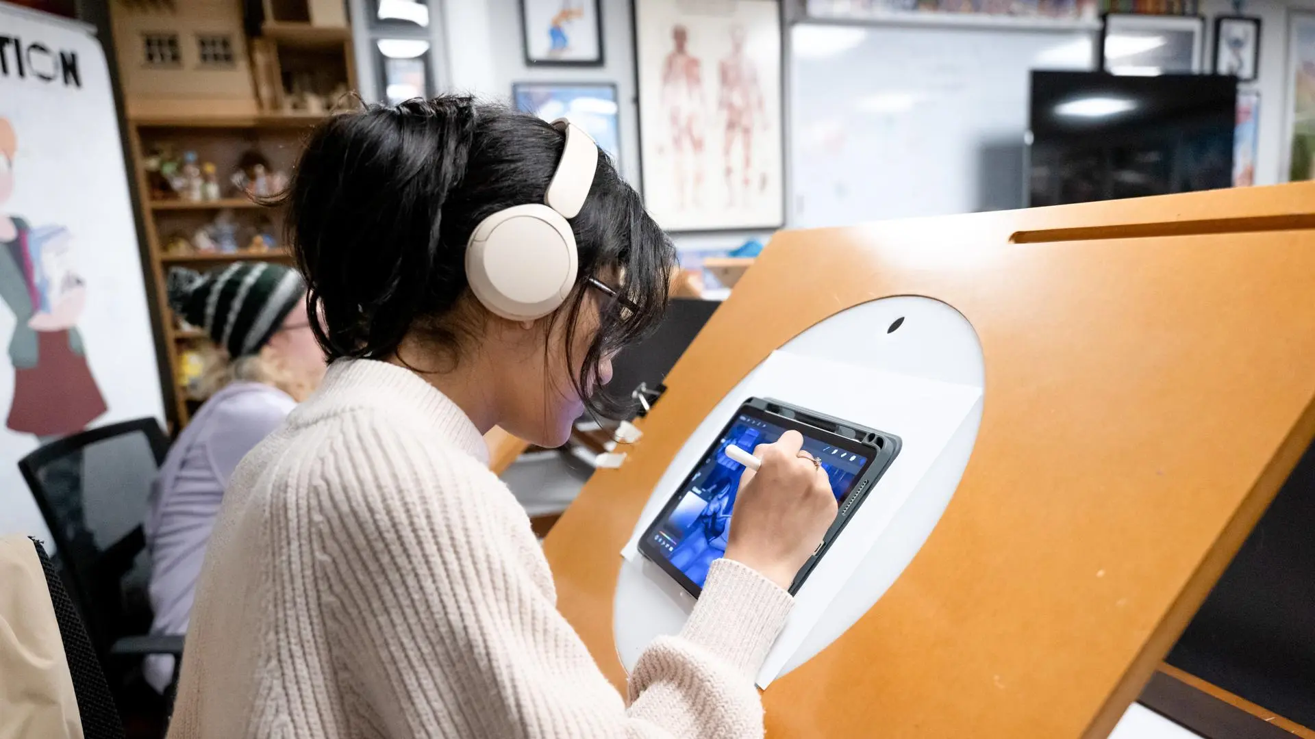 Student working on a digital tablet on a lightbox