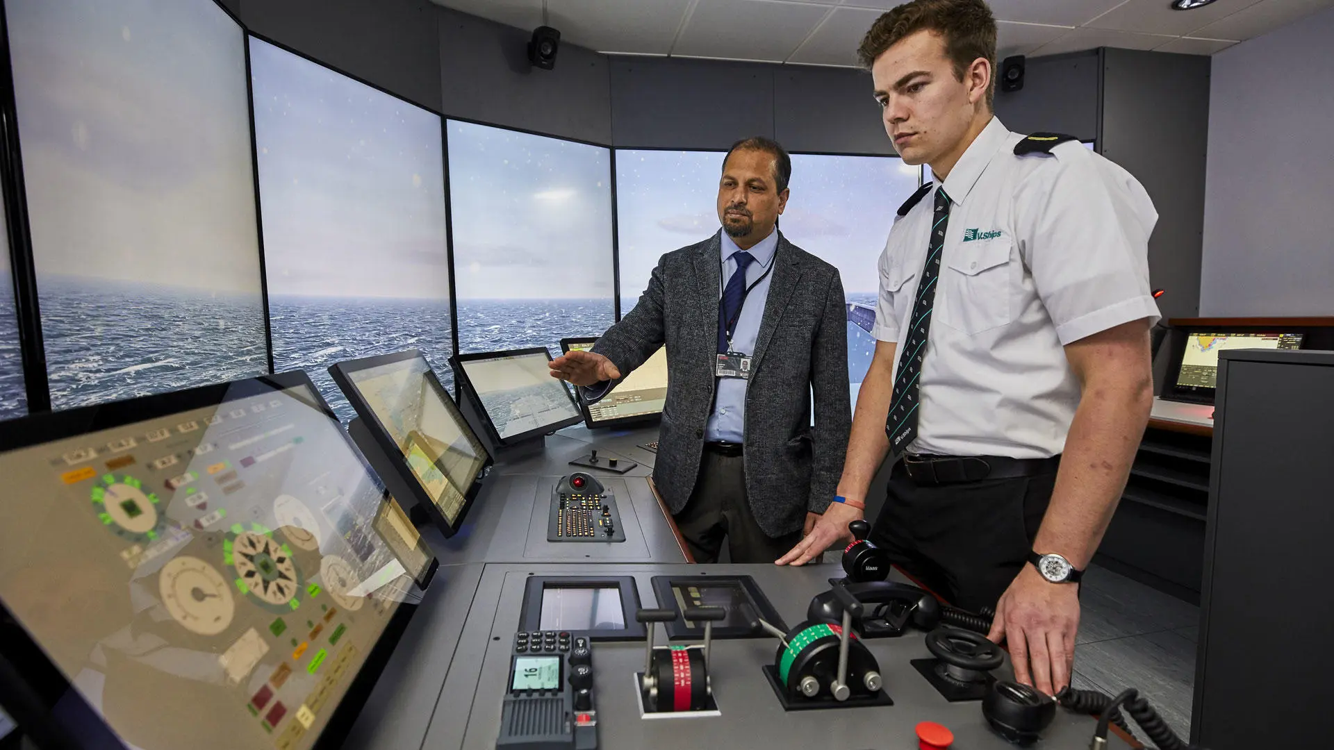 Deck cadet with instructor in the bridge simulator