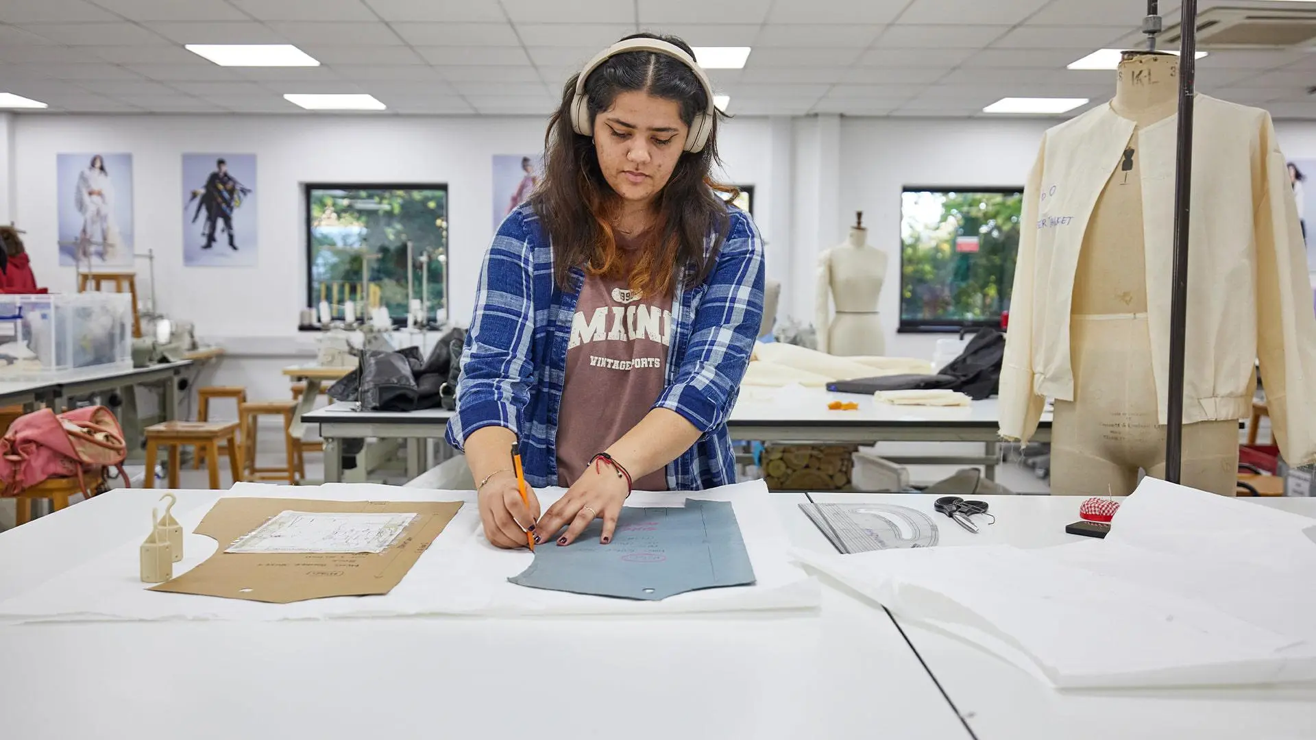 Student cutting out a pattern in the fashion studio