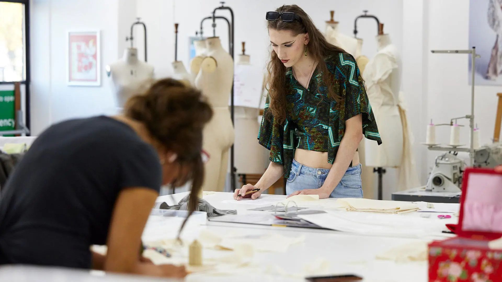 Students wokring on their designs in fashion design studio