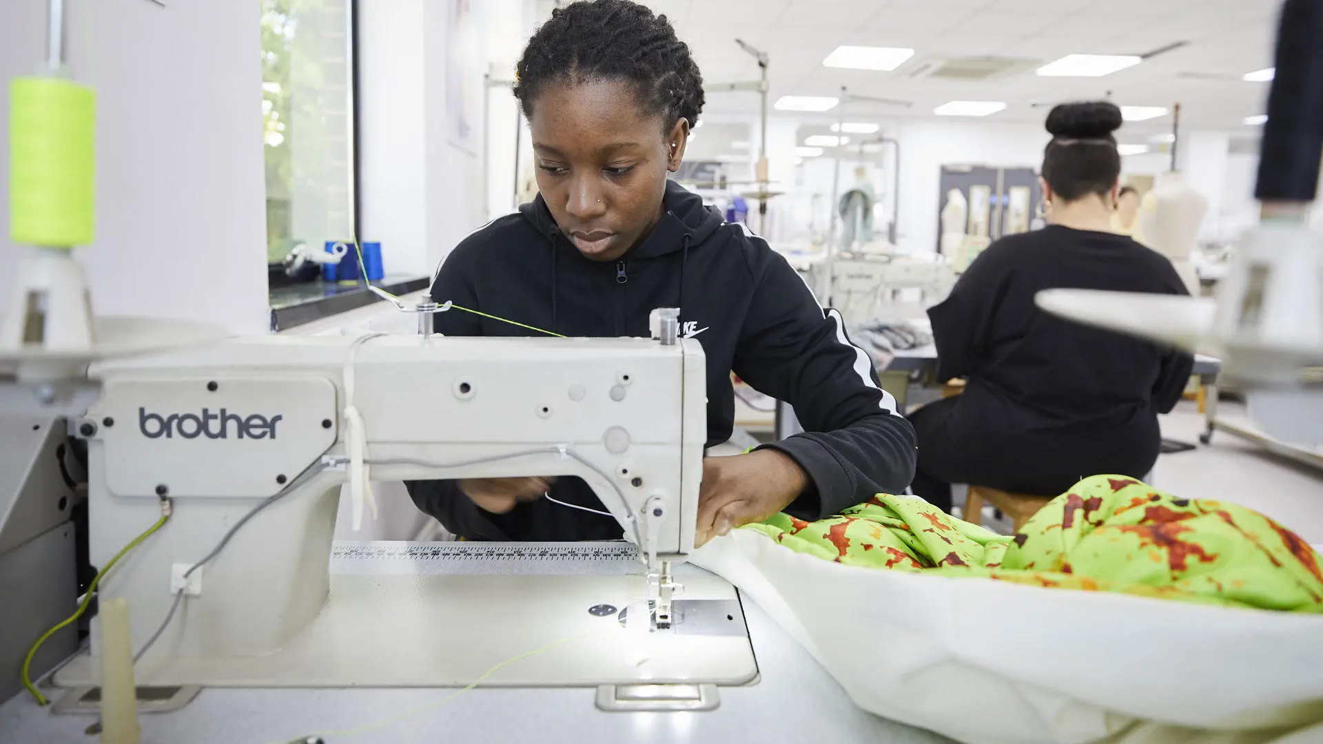 Fashion student using a sewing machine