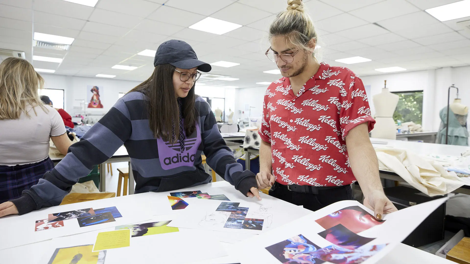 Fashion students looking at designs