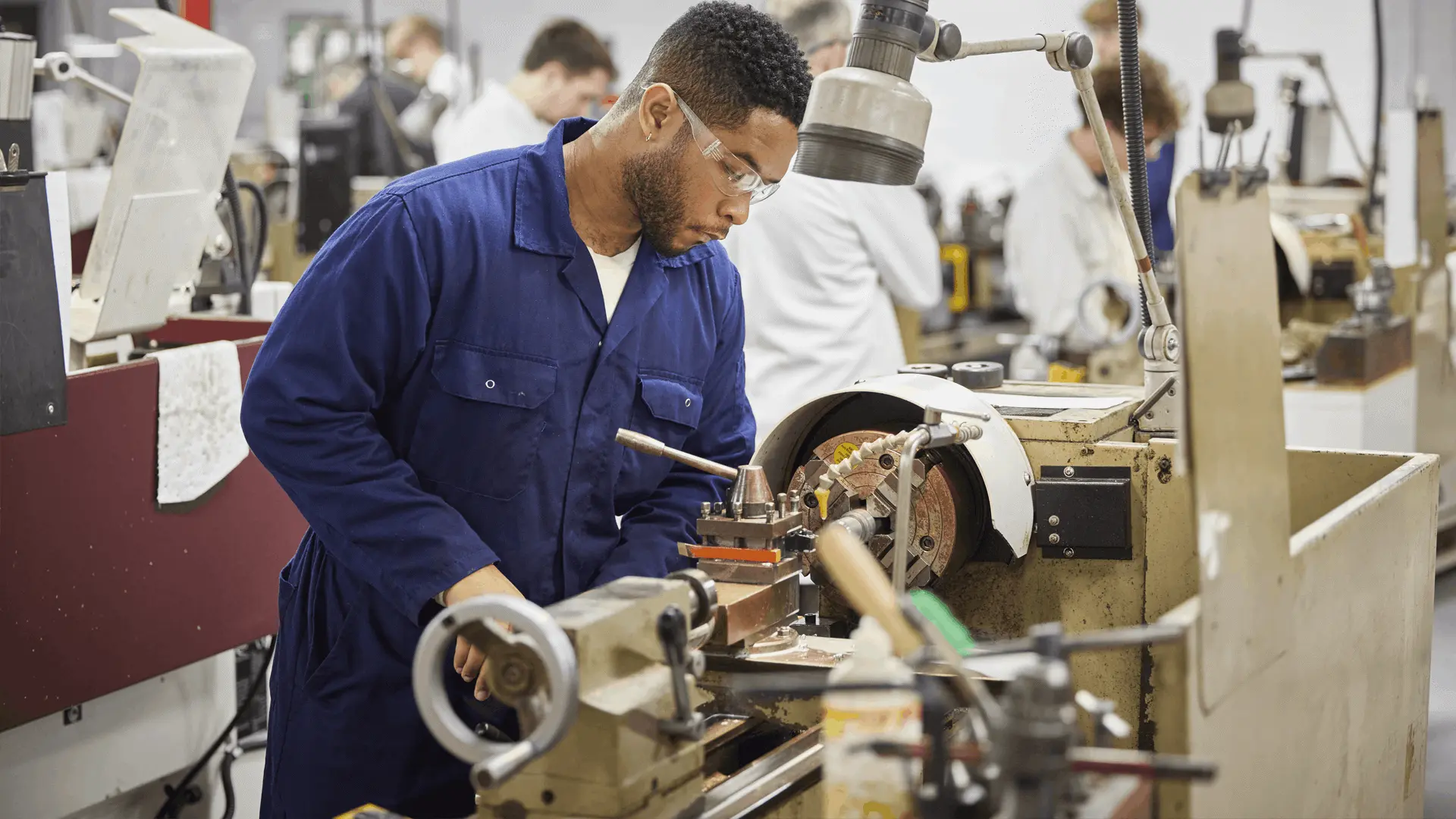 A student using the lathe in the marine engineering workshop