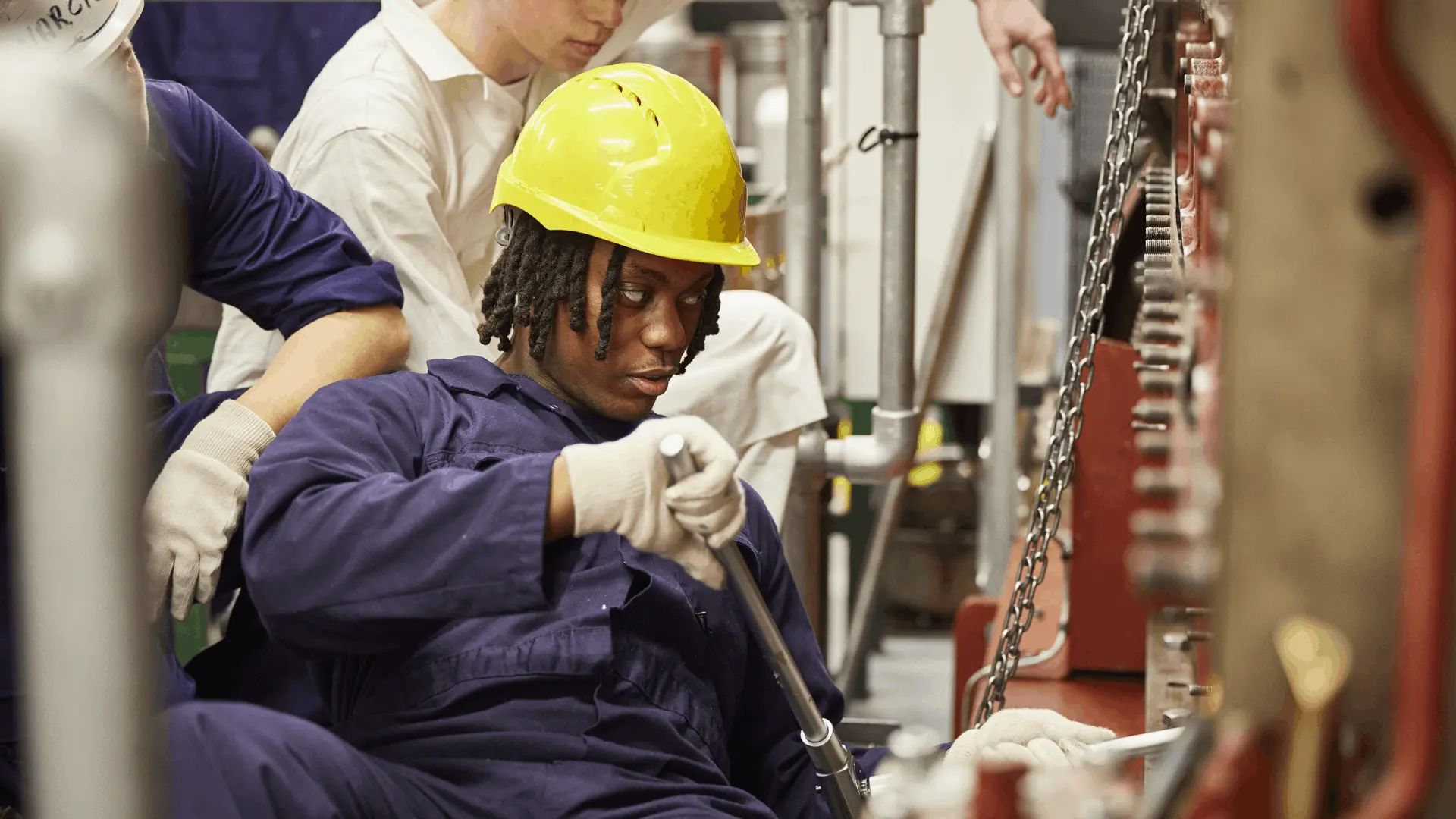 A marine engineering student fixing a piece of machinery