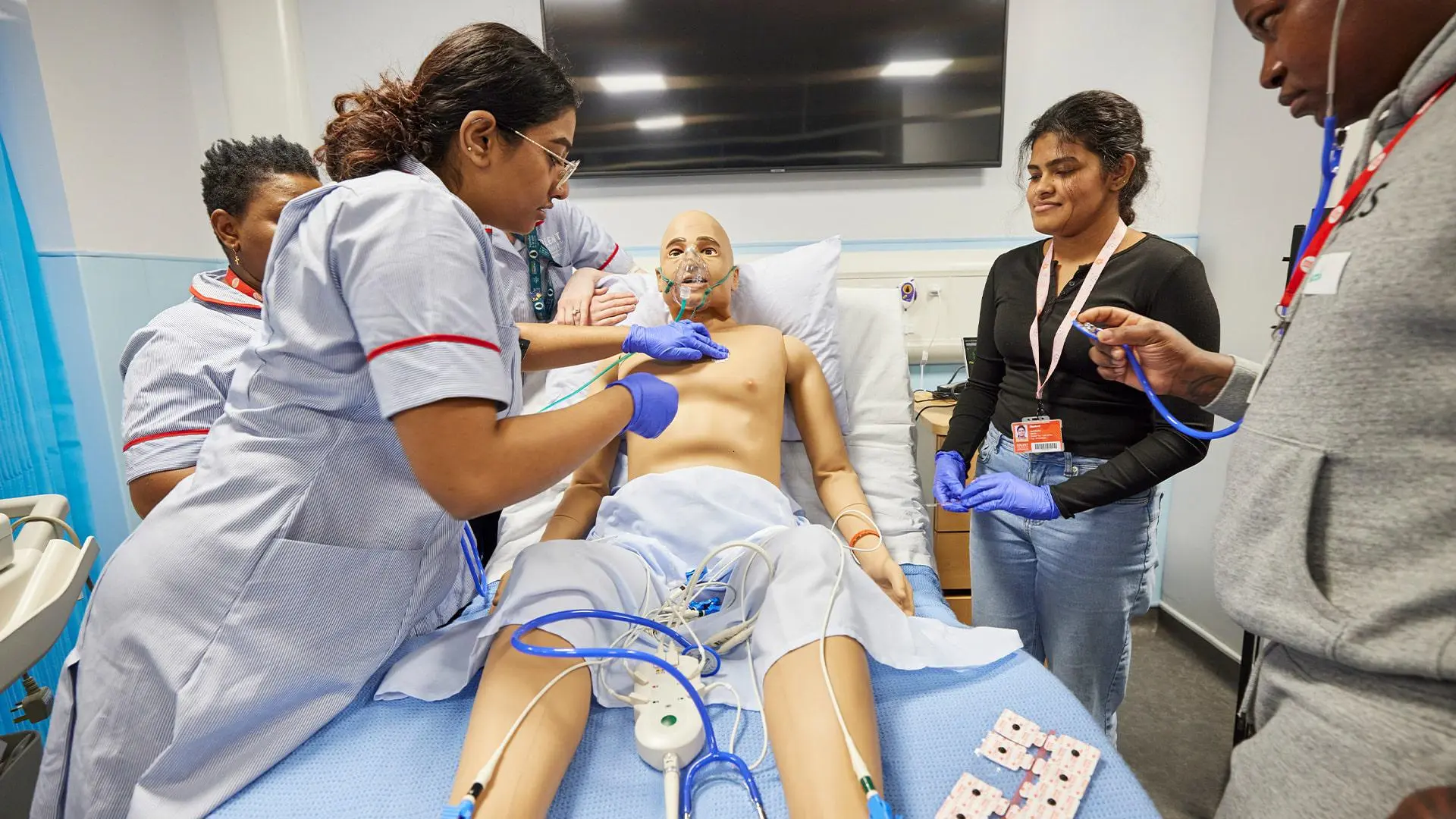 Students working with Nursing Anne simulator