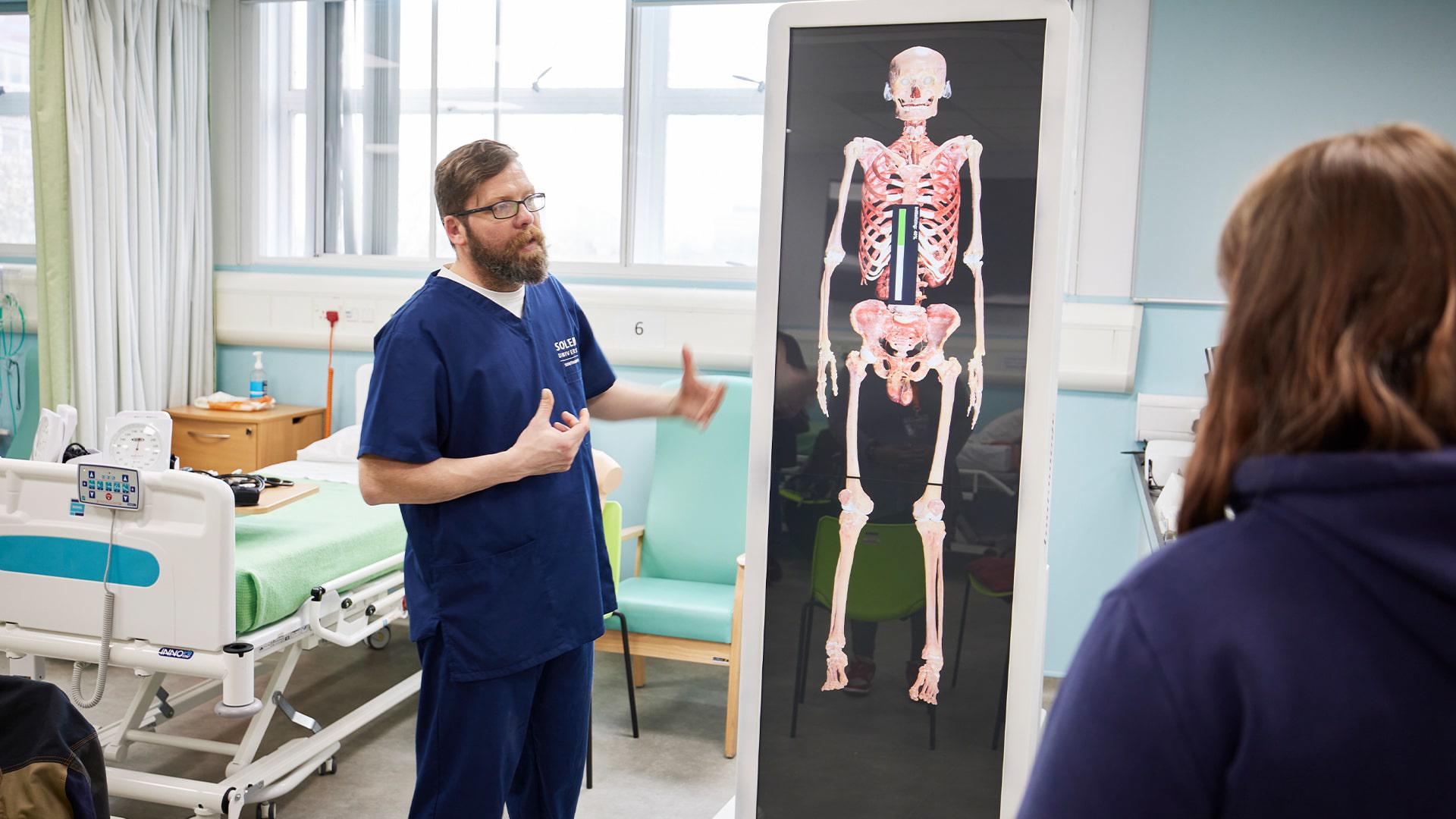 Lecturer teaching using the anatomage
