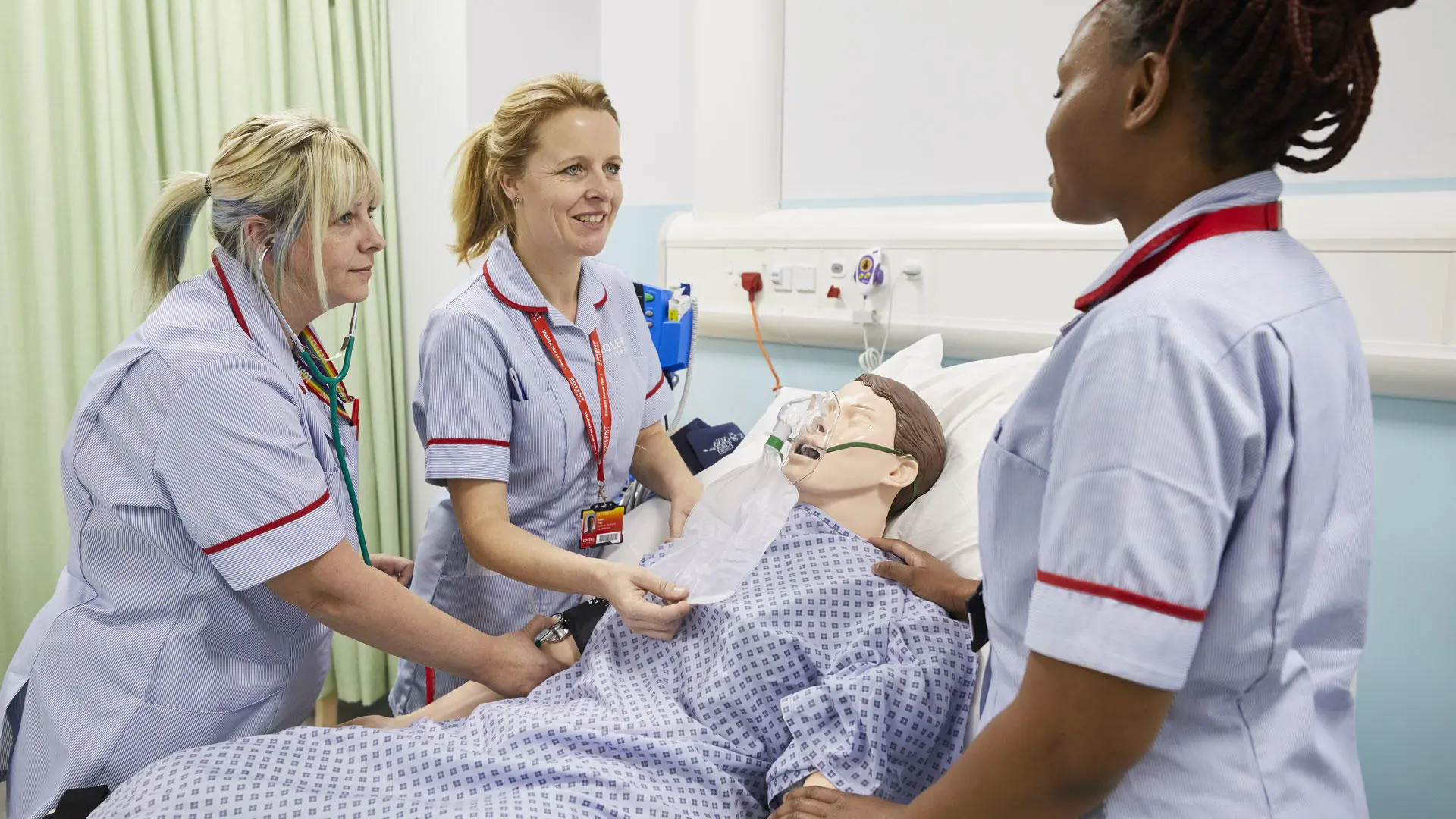 Students working with Nursing Anne simulator