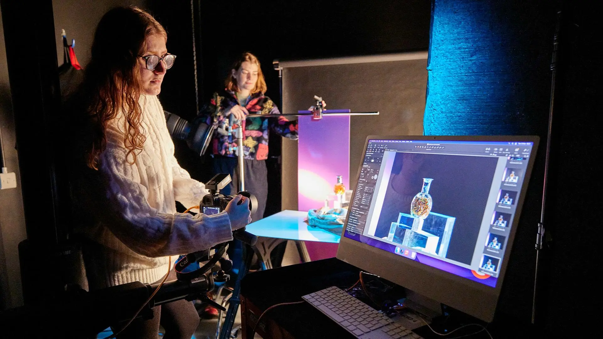 Students wotking in the photography studio with gels and reflectors
