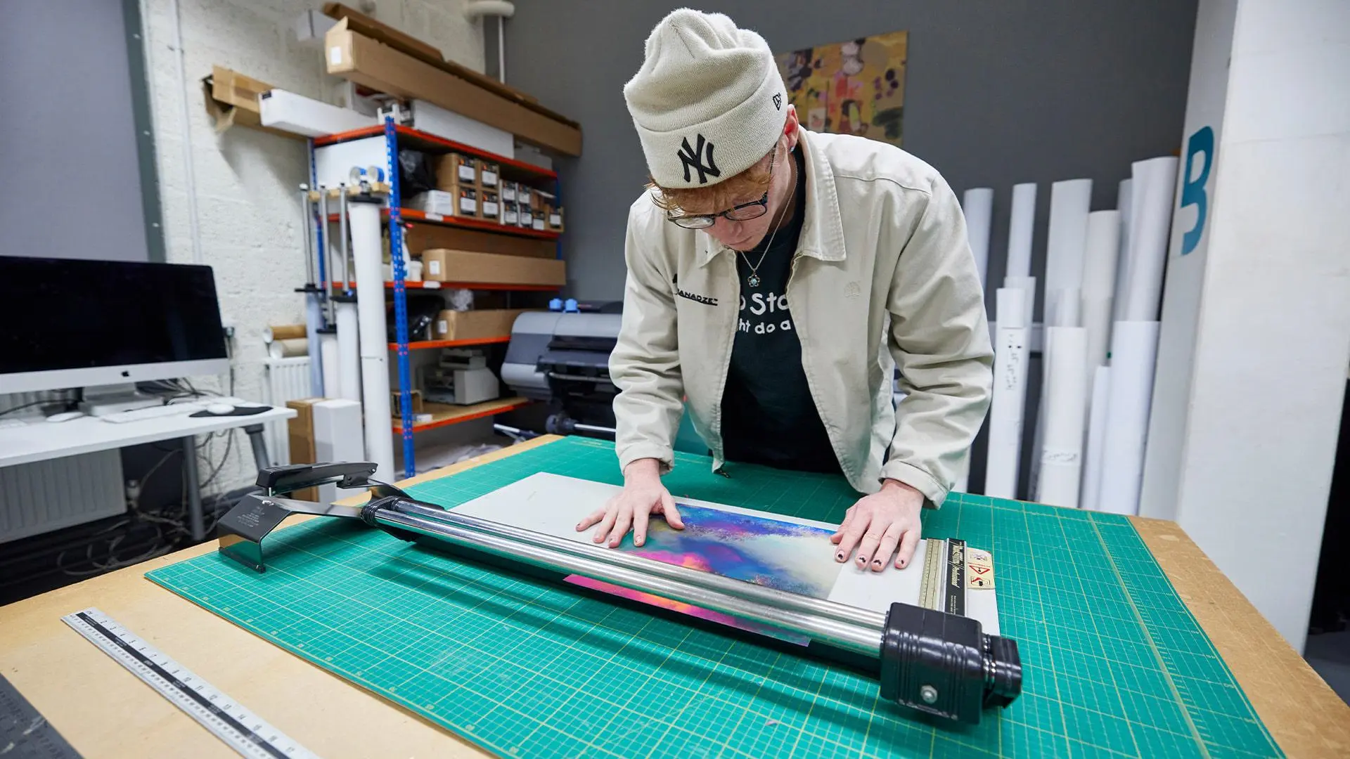Student using guillotine in Specialist printing and reprographics studio