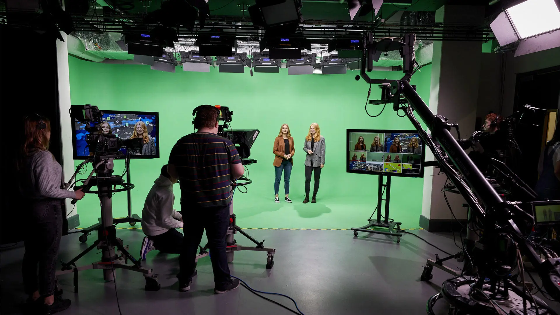 Students in the studio in front of a green screen