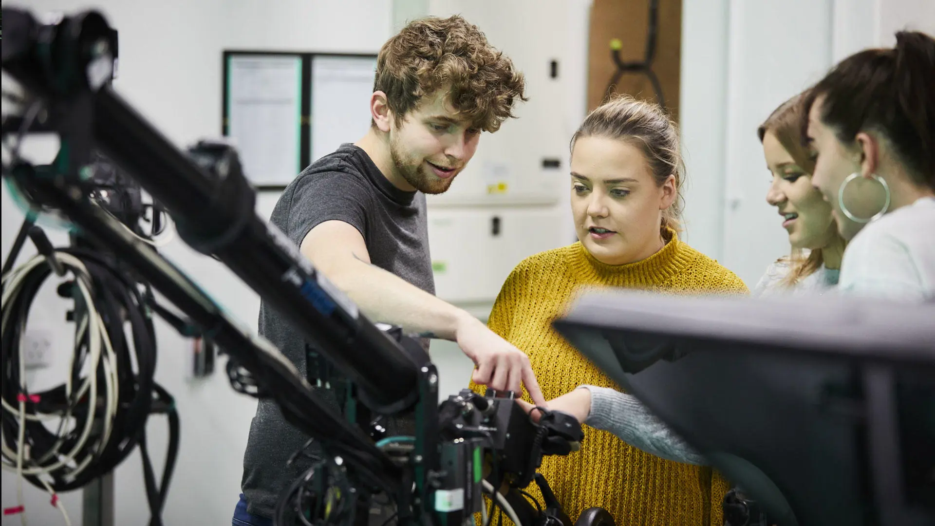 Students looking at camera equipment