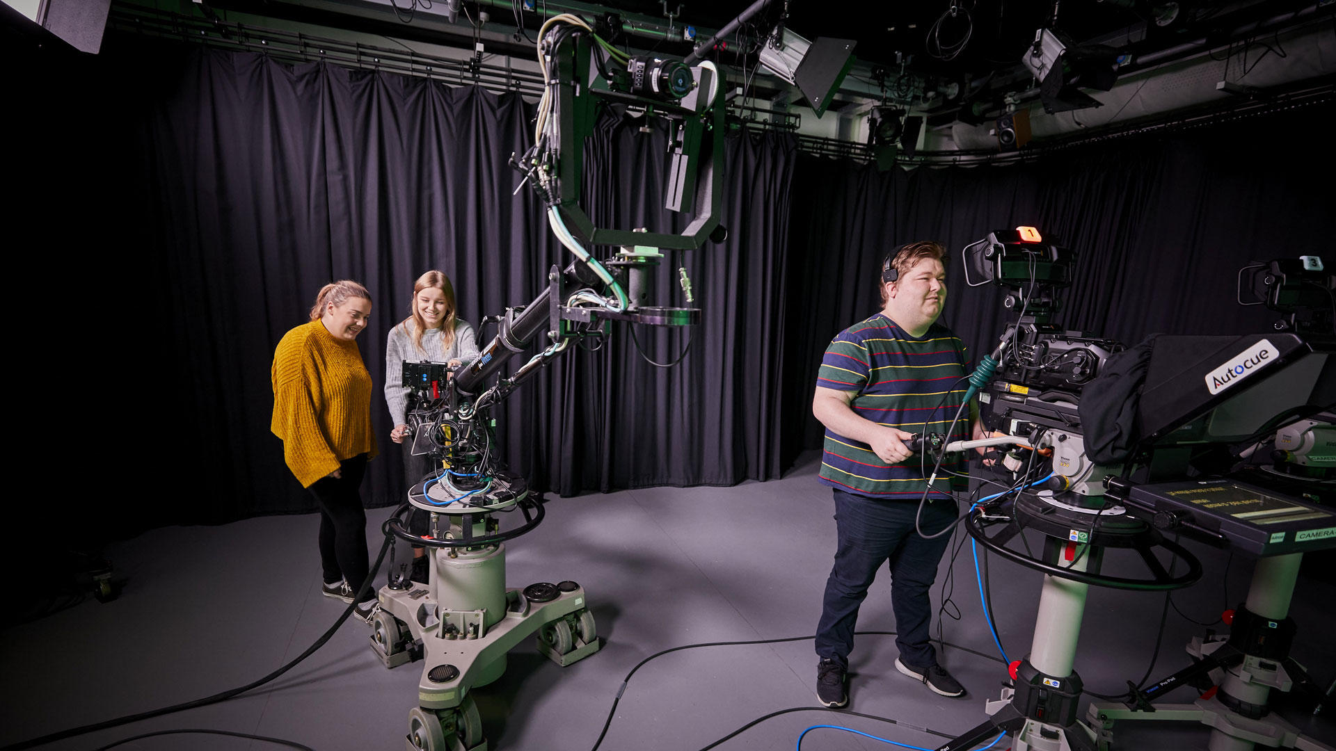 Students operating cameras in the television studios