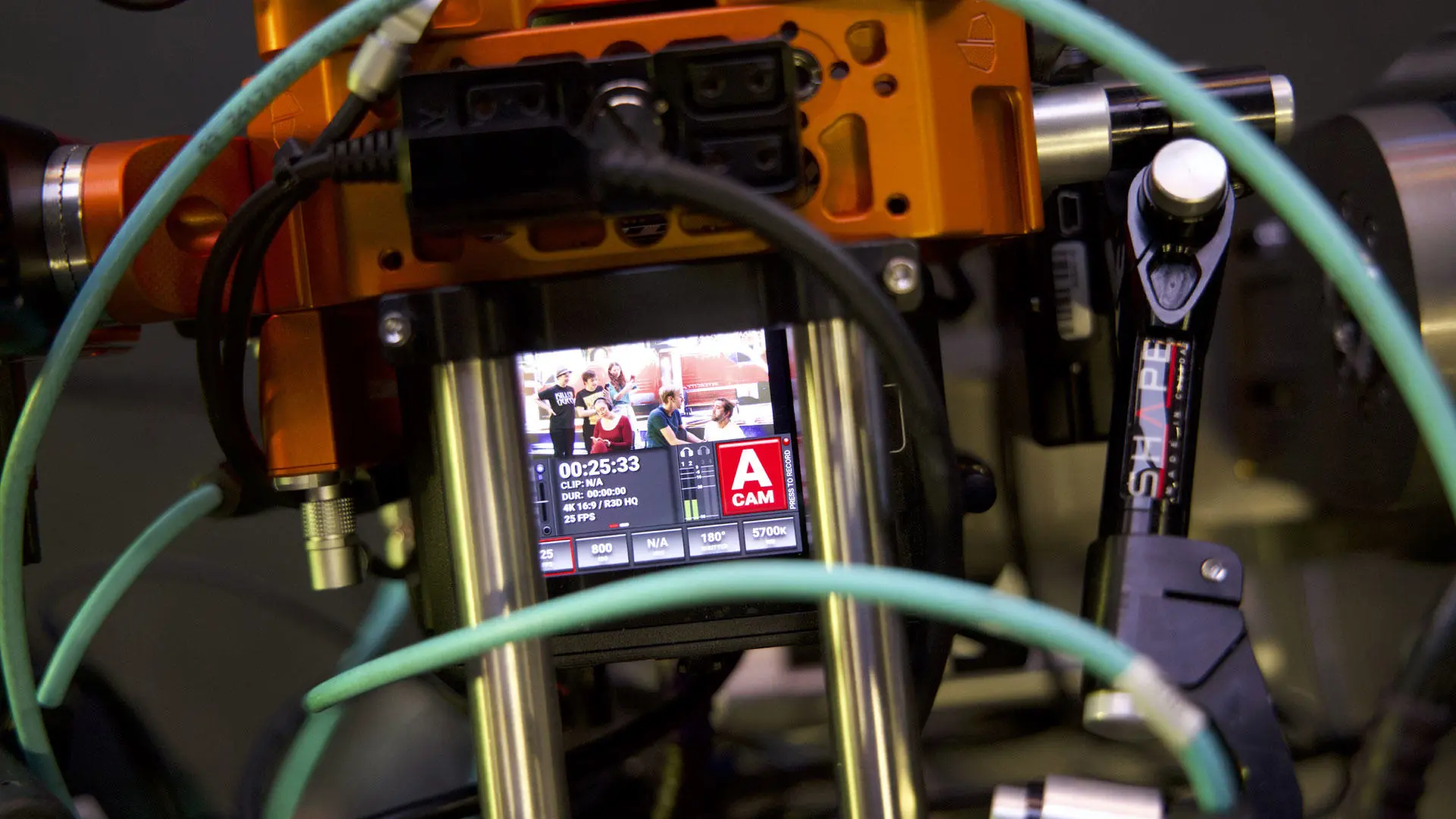 Close-up of a camera display showing students using the virtual production stage