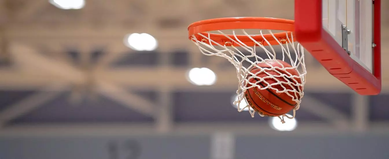 Basketball being thrown through the hoop