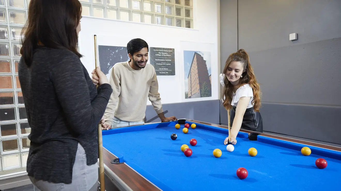 Students playing pool in the common room in Deanery residence