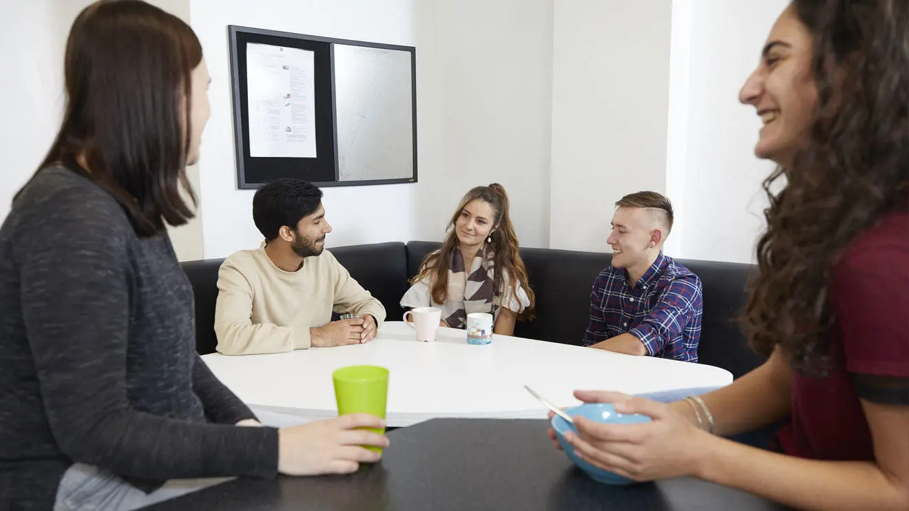 Students socialising in a kitchen in Deanery residence