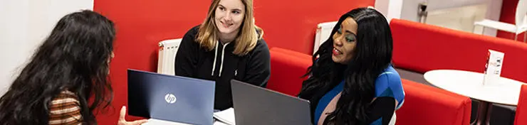 Three female students working together