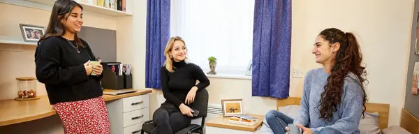 Three female students in a room in the student residences