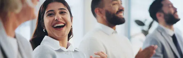 Business people sat in a row smiling