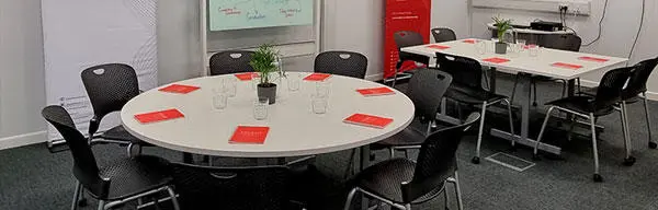 Tables and chairs set up for a meeting