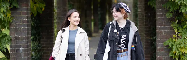 Two students walking in the park
