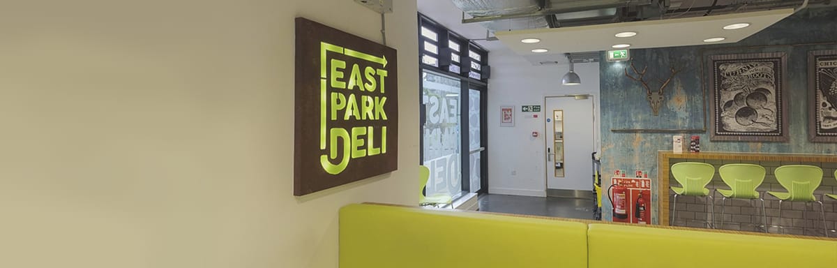A sign which says East Park Deli
