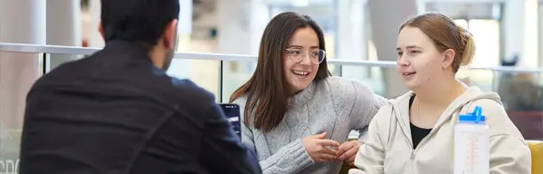 Three students talking to each other