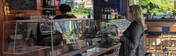 A customer being served in a coffee shop